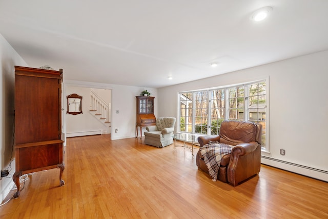 living area with baseboard heating and light wood-type flooring