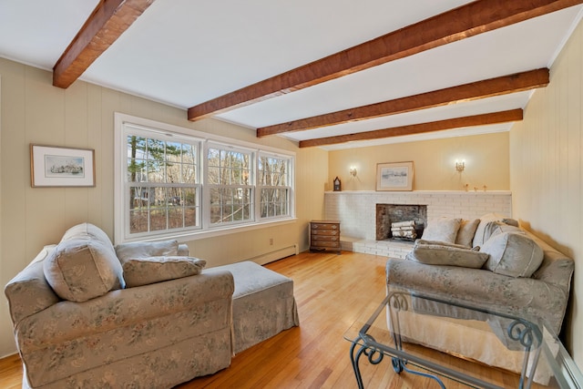 living room featuring a fireplace, light hardwood / wood-style flooring, beamed ceiling, and a baseboard heating unit