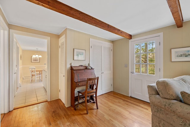 interior space featuring beam ceiling, a chandelier, and light hardwood / wood-style floors