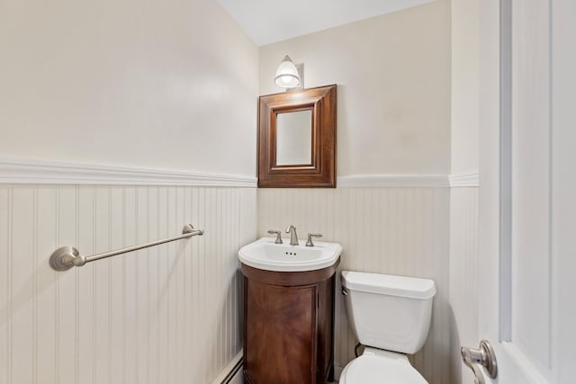 bathroom featuring vanity, toilet, and lofted ceiling