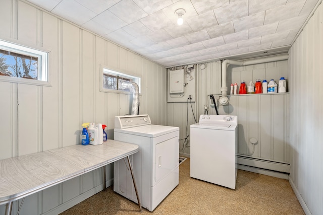 laundry area featuring independent washer and dryer, plenty of natural light, and baseboard heating