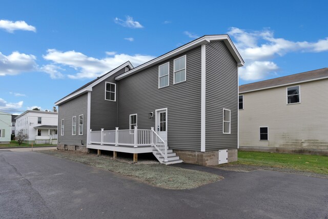 back of property with a wooden deck