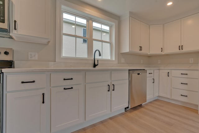 kitchen with white cabinetry, sink, light wood-type flooring, and stainless steel appliances