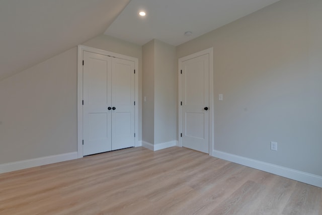 bonus room featuring light hardwood / wood-style floors and vaulted ceiling