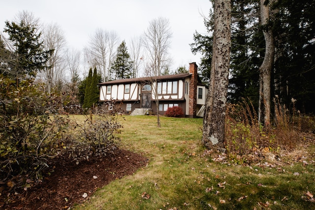 rear view of property with a yard