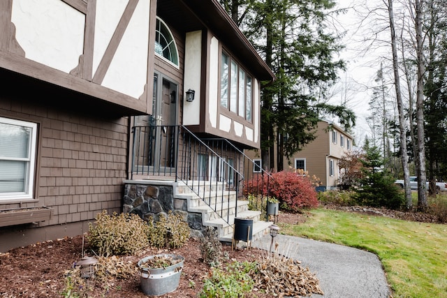 view of side of property with a lawn