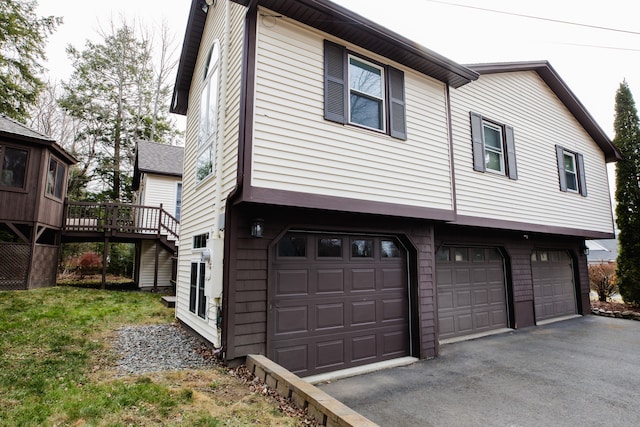 exterior space with a garage and a wooden deck