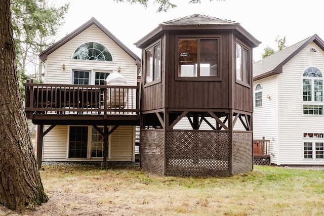 back of house with a deck