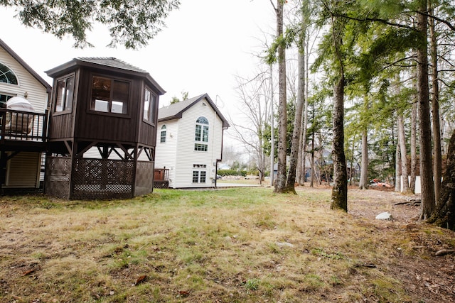 rear view of house featuring a lawn