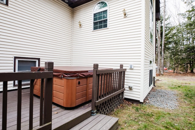 wooden terrace featuring a hot tub