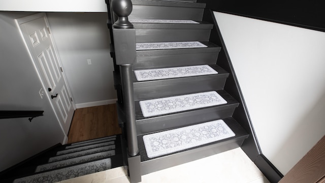 staircase featuring hardwood / wood-style flooring