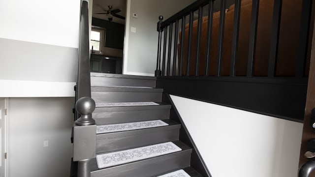 stairway with ceiling fan