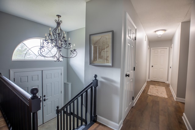 foyer featuring dark hardwood / wood-style floors and an inviting chandelier