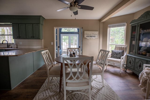 dining room featuring dark hardwood / wood-style floors, ceiling fan, and sink