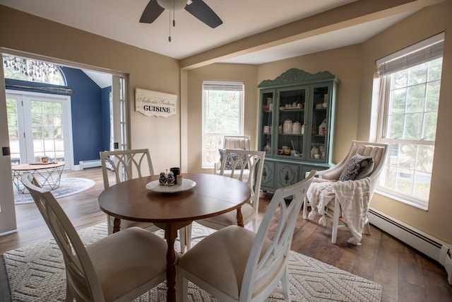 dining space with hardwood / wood-style flooring, ceiling fan, a healthy amount of sunlight, and baseboard heating