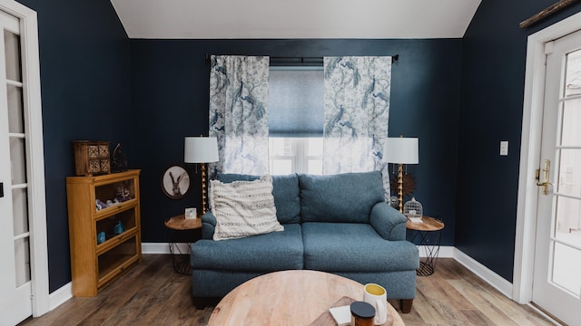 sitting room with hardwood / wood-style floors and lofted ceiling