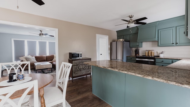 kitchen featuring tasteful backsplash, premium range hood, stainless steel appliances, dark wood-type flooring, and stone counters