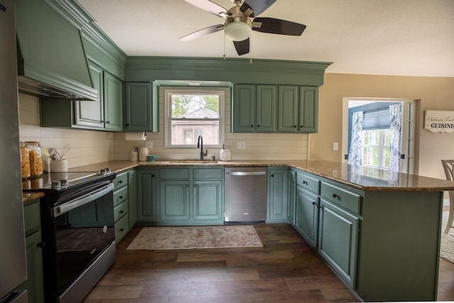 kitchen featuring kitchen peninsula, appliances with stainless steel finishes, custom exhaust hood, sink, and dark hardwood / wood-style floors