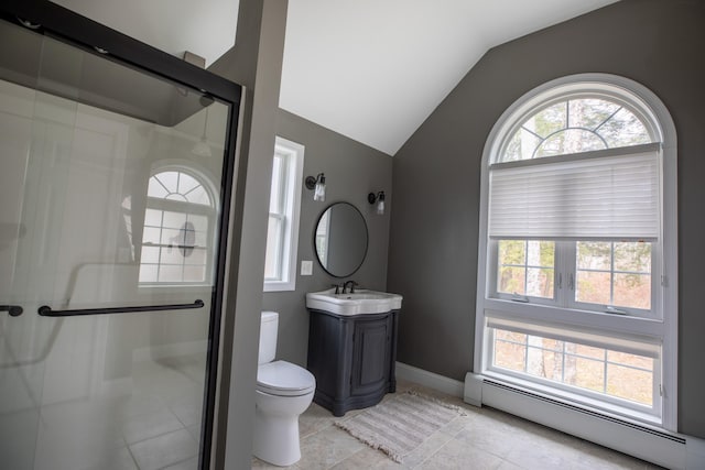 bathroom with tile patterned floors, vanity, vaulted ceiling, baseboard heating, and toilet