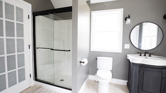 bathroom with tile patterned floors, vanity, toilet, and a shower with shower door