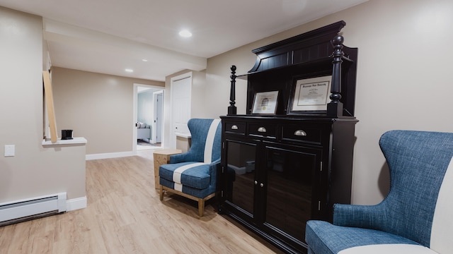 sitting room featuring light hardwood / wood-style floors and a baseboard heating unit