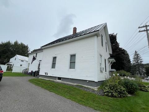 view of home's exterior with a lawn