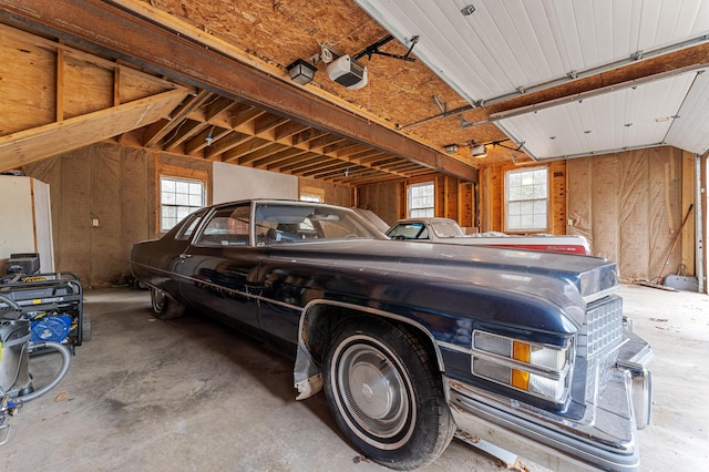 garage featuring a garage door opener and a carport