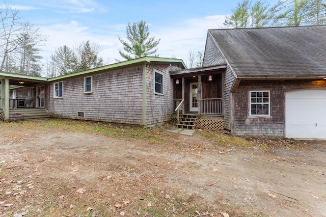 view of front facade with a porch and a garage