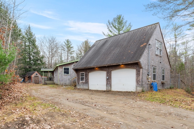 view of side of home with a shed