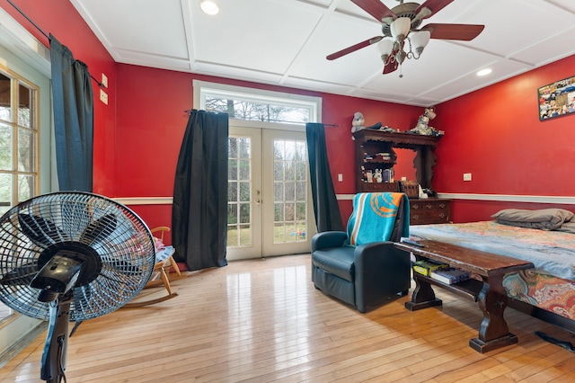 bedroom featuring multiple windows, ceiling fan, french doors, and light hardwood / wood-style floors