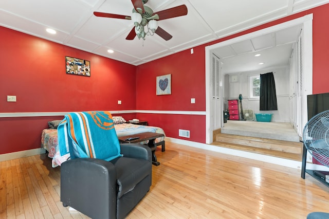 living area featuring hardwood / wood-style floors and ceiling fan