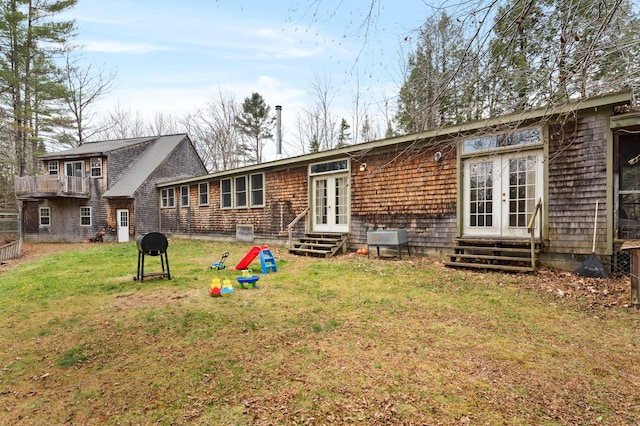 back of property featuring french doors and a yard