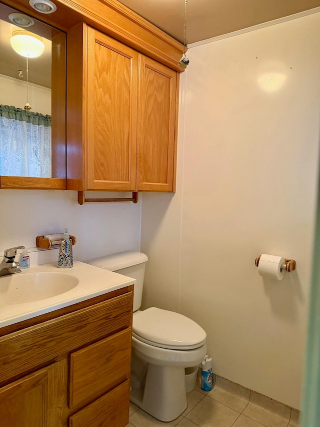 bathroom featuring tile patterned floors, vanity, and toilet