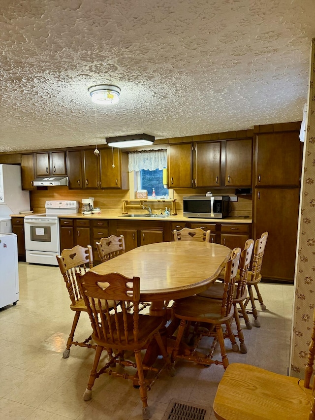 dining room with sink and a textured ceiling