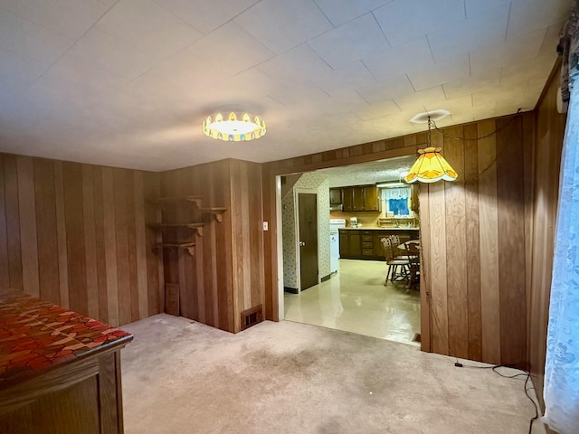 interior space featuring wooden walls and concrete flooring