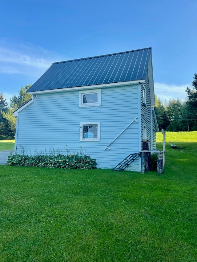 view of side of home featuring a yard