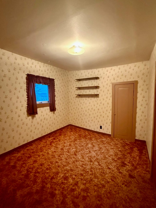 unfurnished room featuring carpet