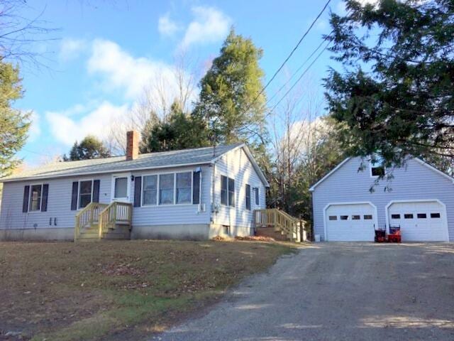 view of front of home featuring a garage and an outdoor structure