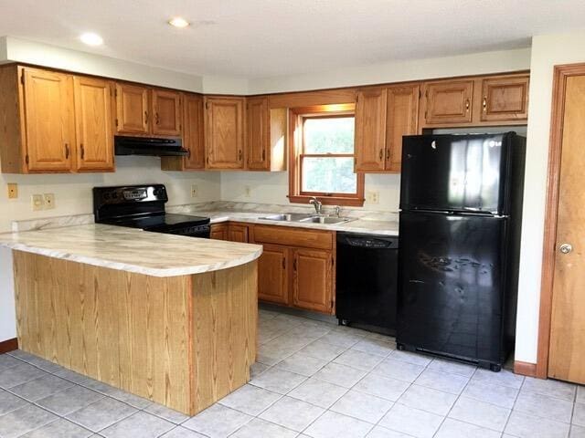 kitchen with black appliances, sink, kitchen peninsula, and light tile patterned floors