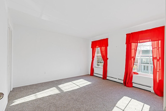 carpeted empty room with a baseboard heating unit