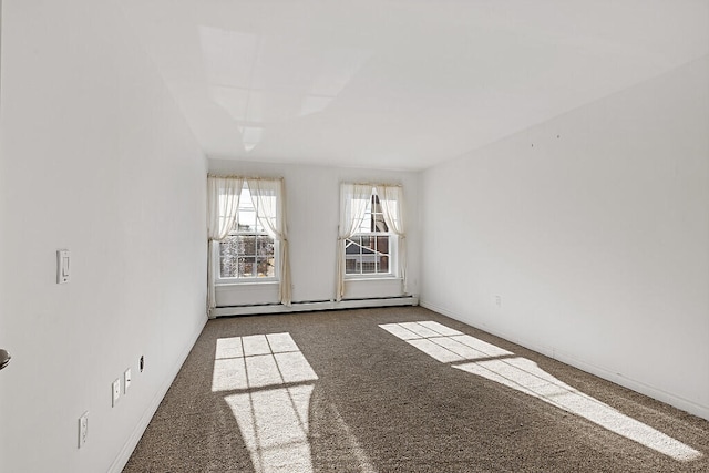 carpeted empty room with baseboard heating