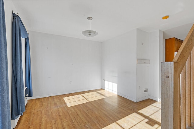 spare room with light hardwood / wood-style flooring