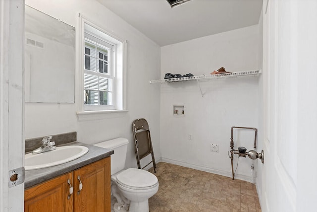 bathroom featuring vanity and toilet