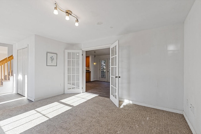 carpeted spare room with french doors