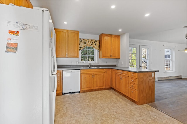 kitchen featuring sink, a baseboard heating unit, kitchen peninsula, white appliances, and light wood-type flooring