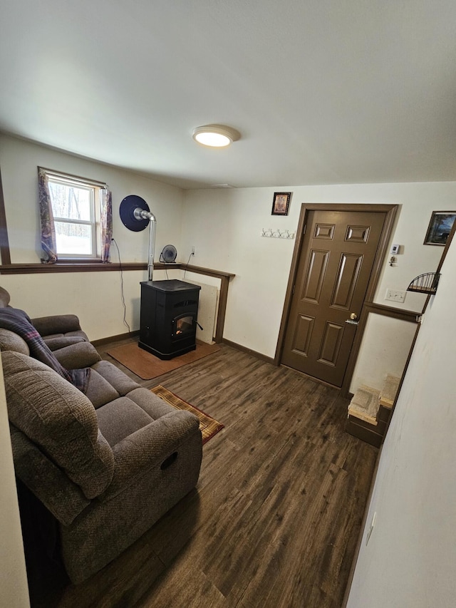 living room featuring dark hardwood / wood-style floors and a wood stove