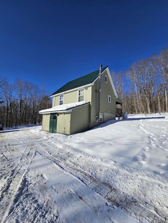 view of snow covered rear of property