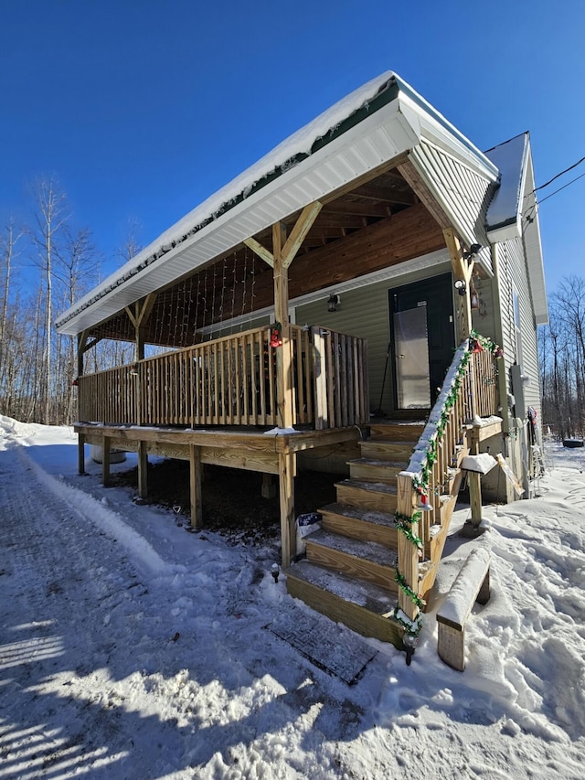 view of snow covered rear of property