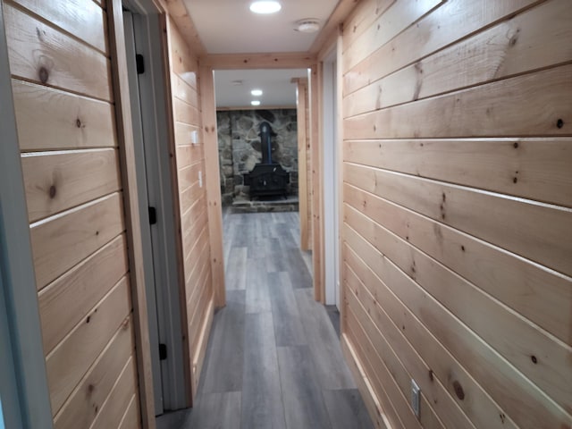 hall with wooden walls and hardwood / wood-style floors