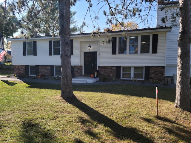 bi-level home with a front lawn